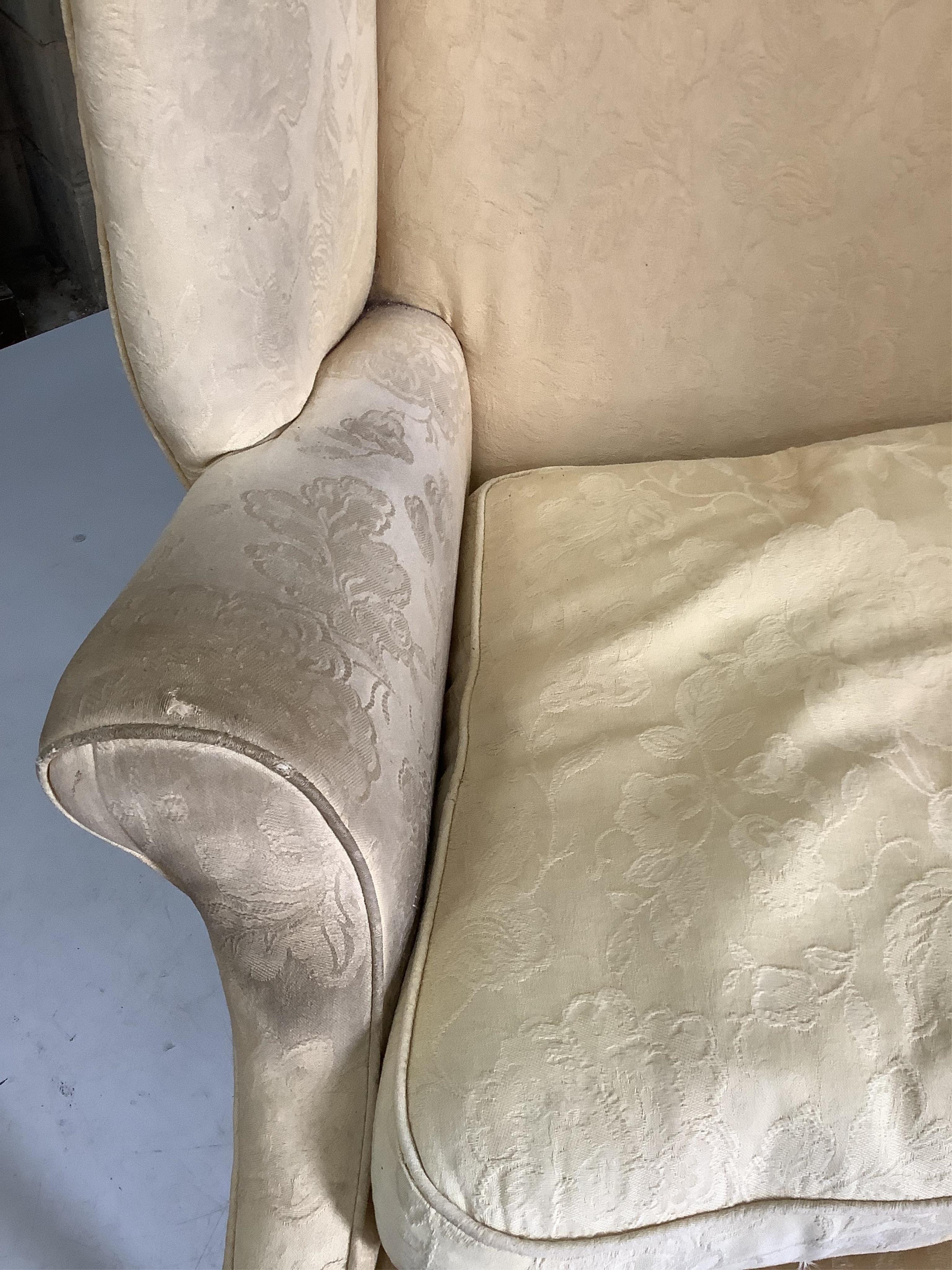 A George III upholstered wing armchair, width 86cm, depth 74cm, height 105cm. Condition - poor to fair